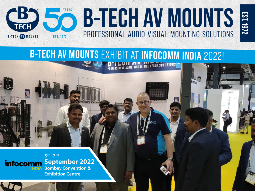 An Image of Jon Alway Standing with a group of men at the B-Tech AV Mounts booth at InfoComm 2022.