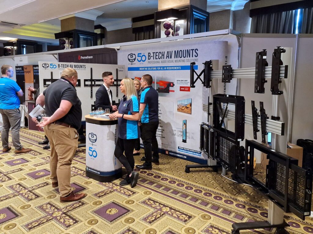 An Image of Dan Horan and Sarah Barnes speaking with customers at midwich Teh expo north