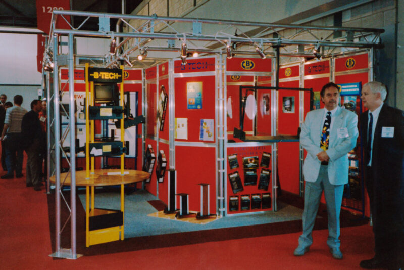 Vintage photo of B-Tech exhibition stand with Martin Bennett and Tom Tucker