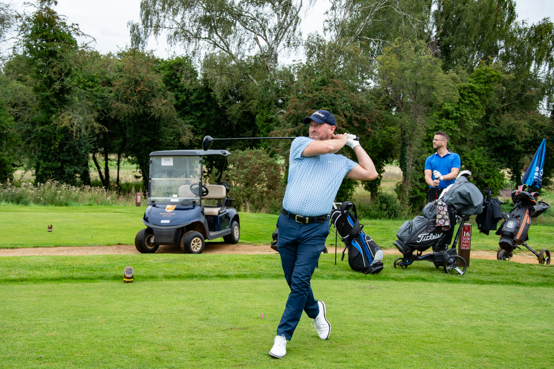 An Image of a man swinging a golf club