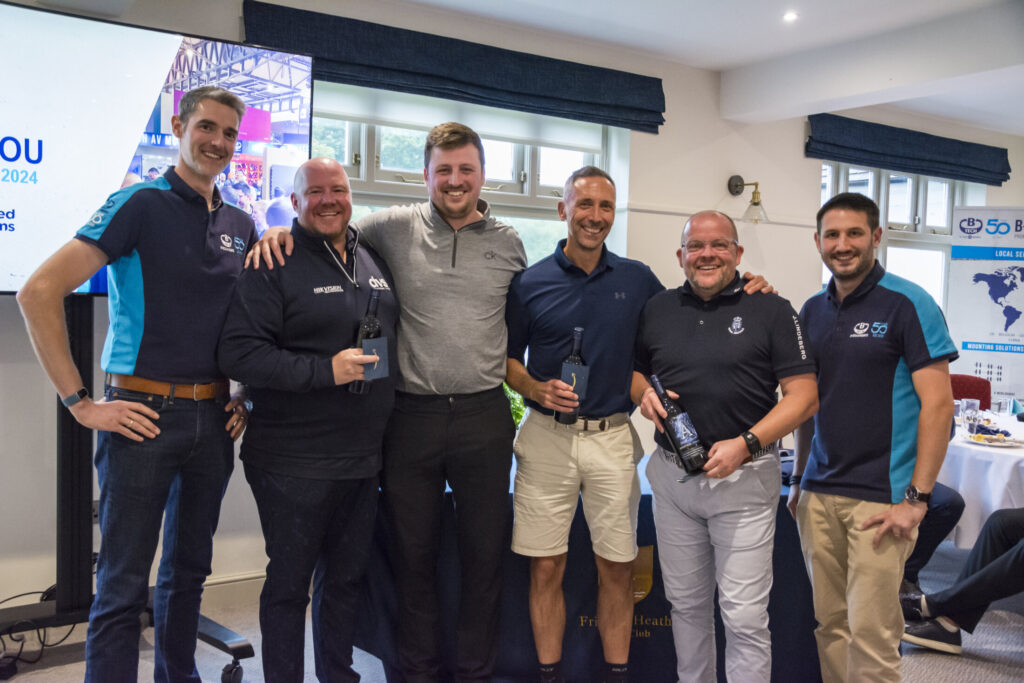 Mark walker and Matt Nixon Smile in a group photo with the winners of the golf day