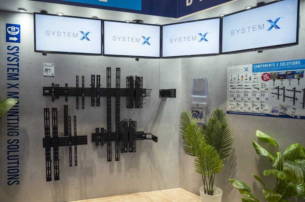 An Image of B-Tech AV Mounts' System X product range mounted underneath an overhead curved Menu board mounted using System X components