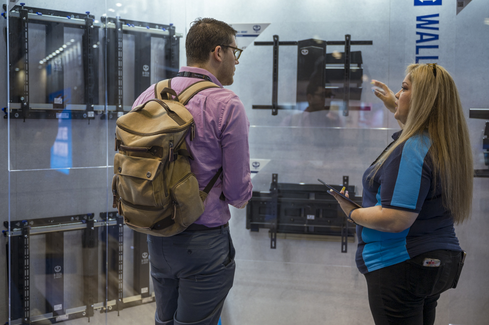 An image of Irene Zuniga presenting BT8226 and BT8237
large screen swivel wall mounts to a customer