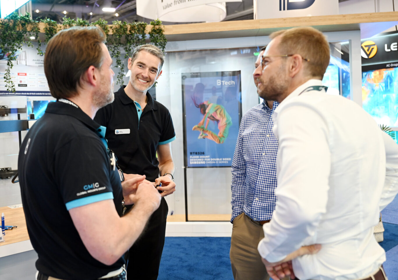 B-Tech AV Mounts team speaking with visitors at an AV industry exhibition