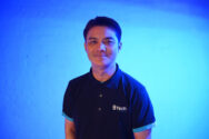 An Image of Nam Lee Standing In front of A Blue background
