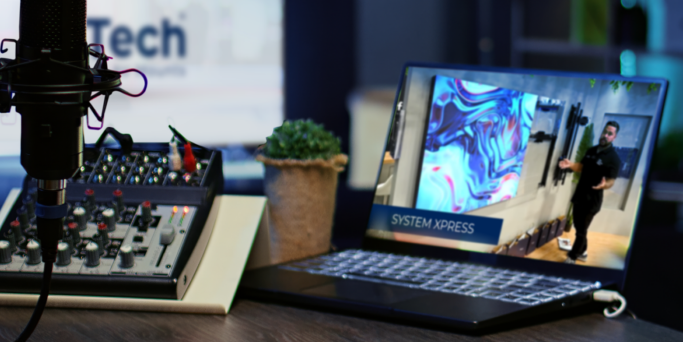 B-Tech AV Mounts press room featuring podcast equipment and a laptop displaying company content